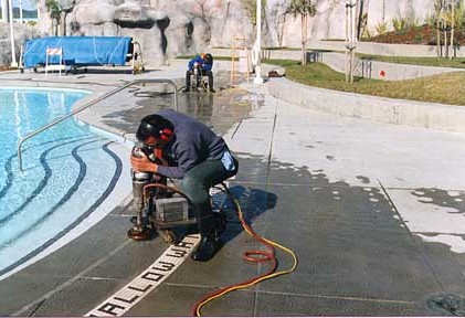A Safety Grooving installation in progress on a pool deck - Diamond Floor Scoring - Anti-slip Treatment - Reduce Slips and Falls