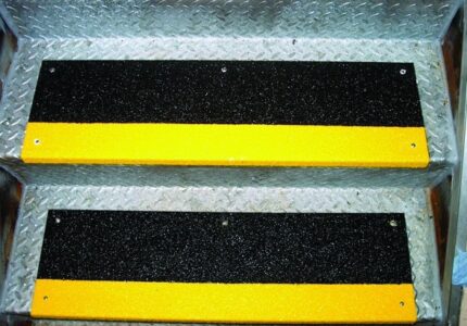 Safeguard Black Step Covers with Yellow Nosing mounted on a metal stairway
